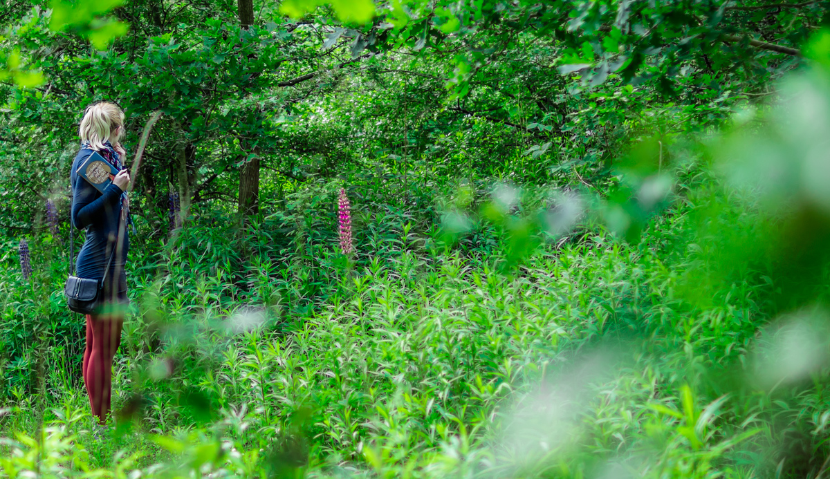 Girl in the woods, holding a book