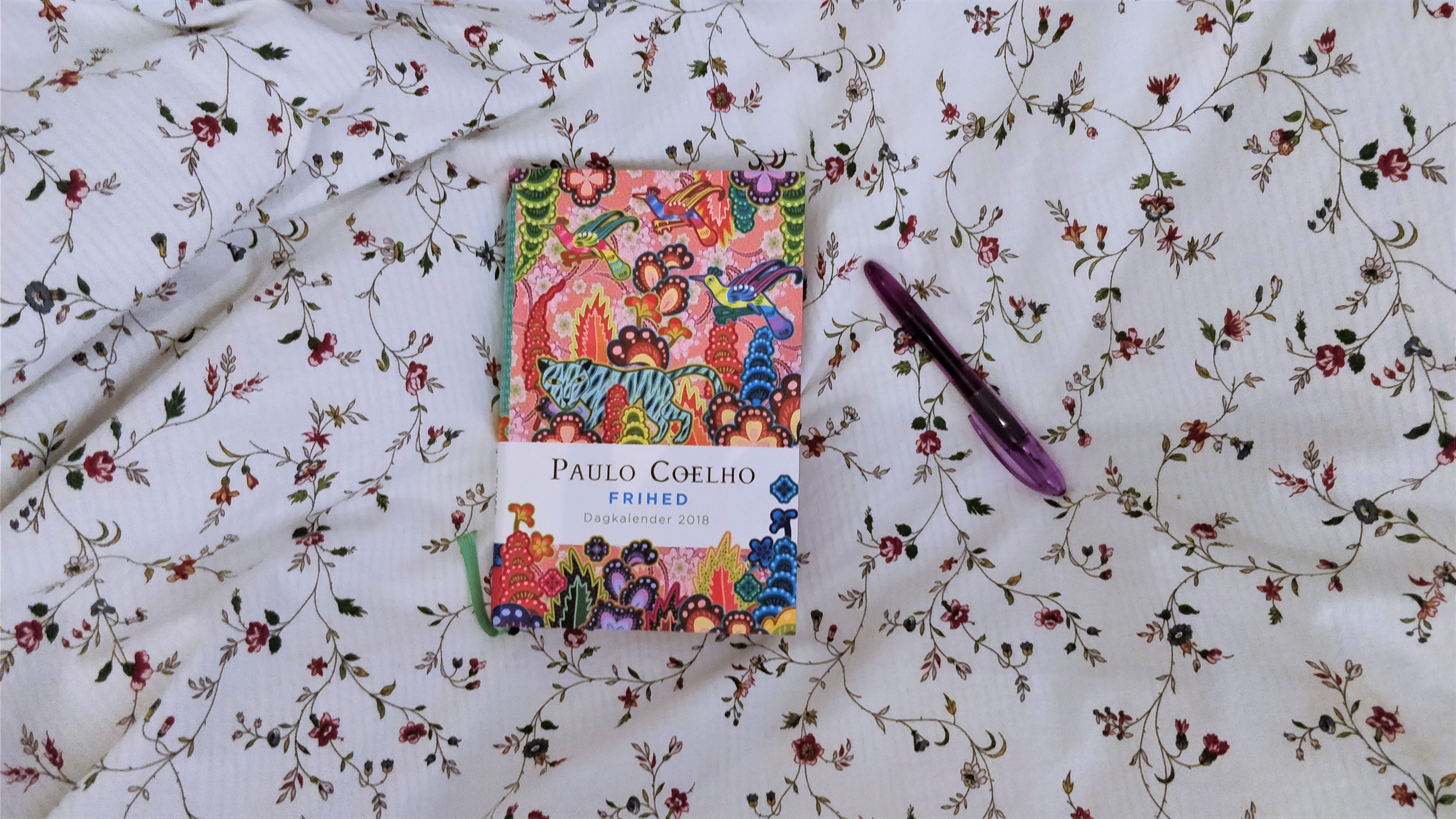 My book journal and a fountain pen on a flowery background