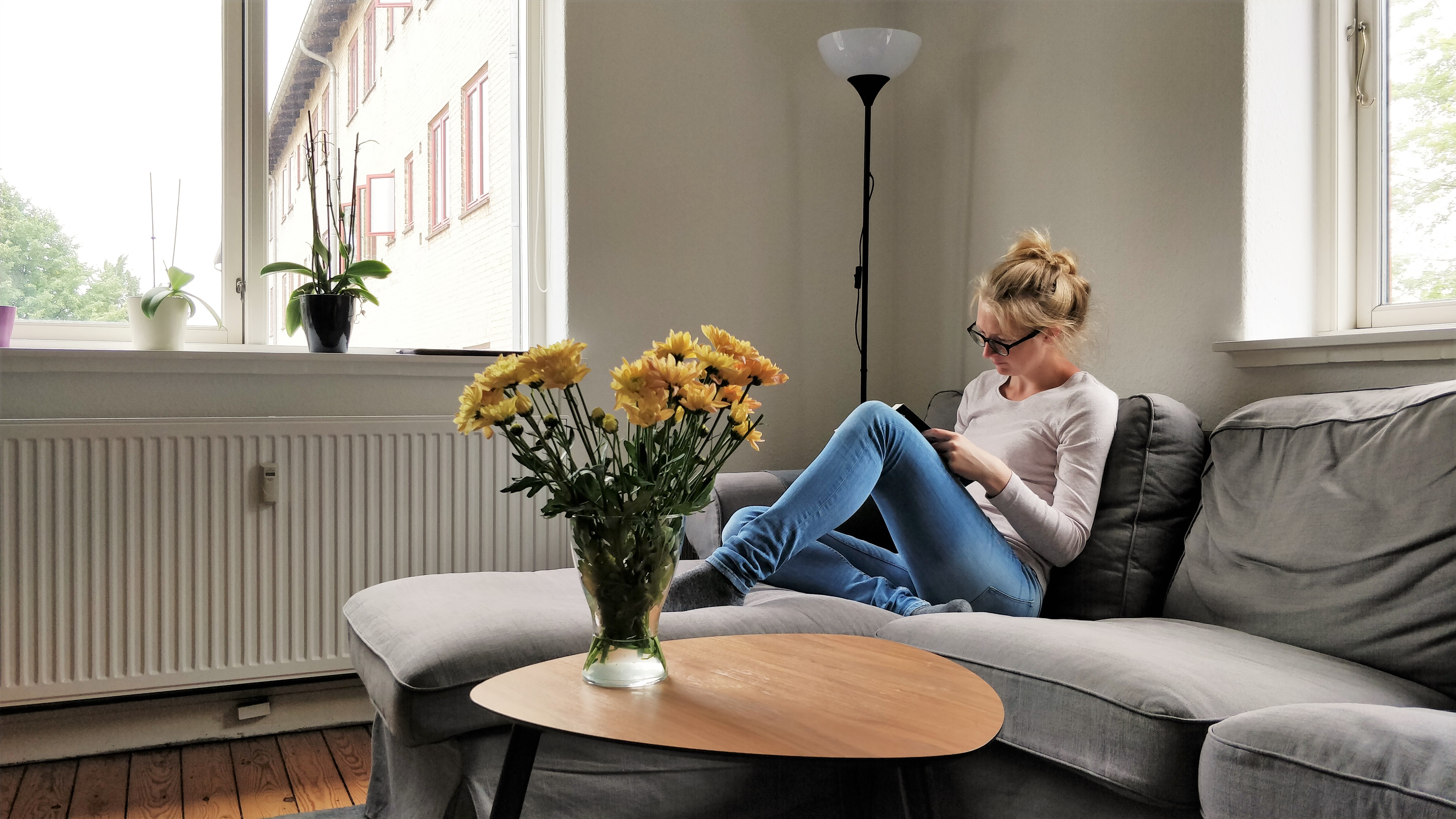 Cherry Blossom reads on her sofa